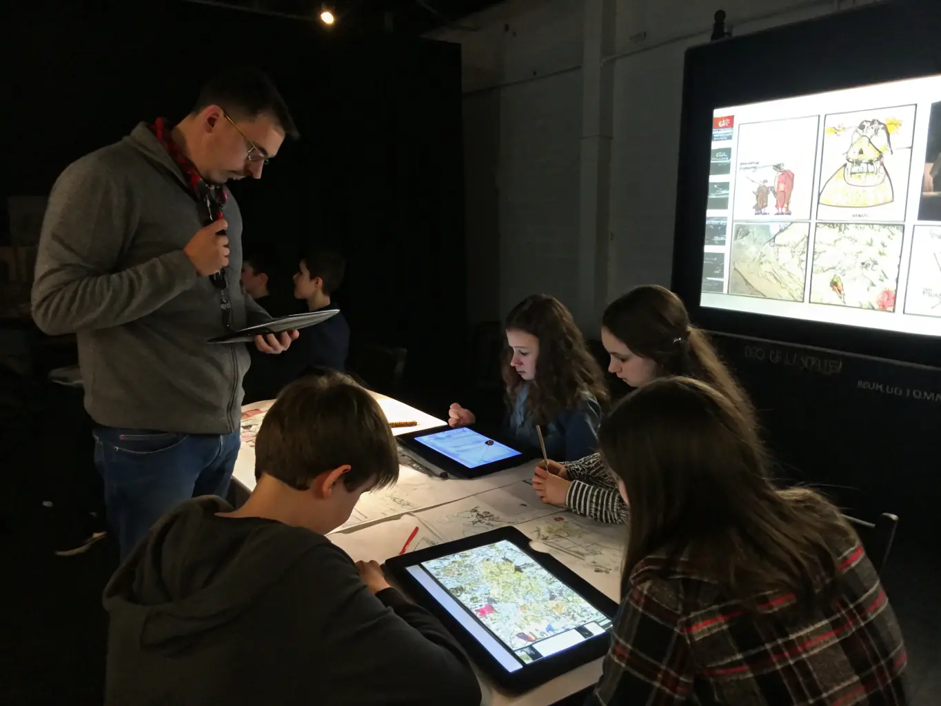 A dynamic shot of a group of teenagers engaged in a digital art and design class at MAISON JEUNES ET DE LA CULTURE, working on computers and tablets, illustrating the center's focus on modern creative skills.